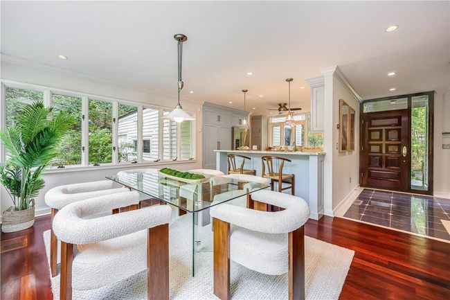 Dining room with crown molding, ceiling fan, sink, and dark hardwood / wood-style flooring | Image 6