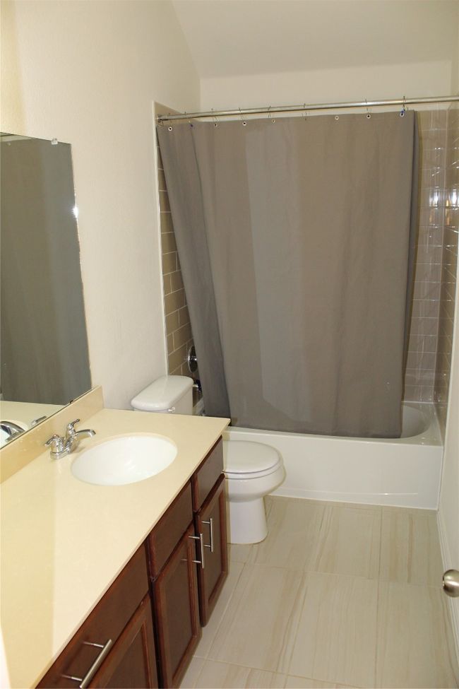 Full bath with toilet, shower / bath combo, and vanity | Image 6