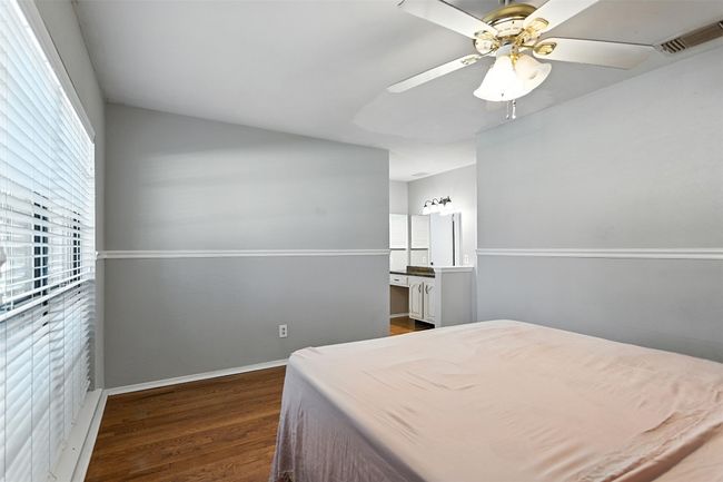 Bedroom featuring dark wood-style flooring and ceiling fan | Image 14