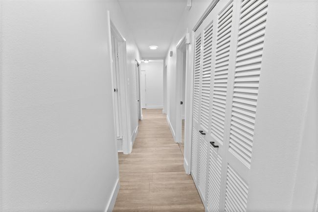 Hall with baseboards and light wood-style floors | Image 22