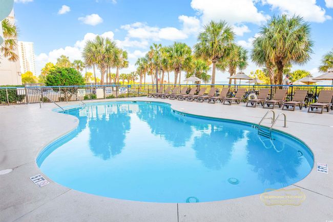 View of swimming pool with a patio | Image 16