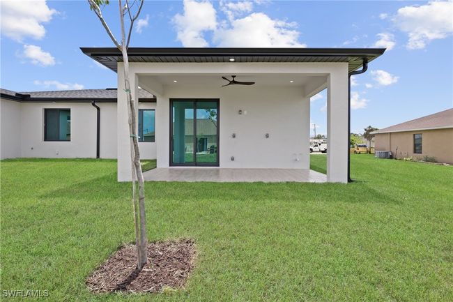 Rear view of property with a patio, stucco siding, central AC unit, ceiling fan, and a lawn | Image 30