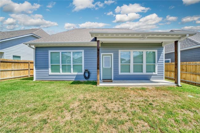 Rear view of property featuring a patio, a fenced backyard, and a shingled roof | Image 33
