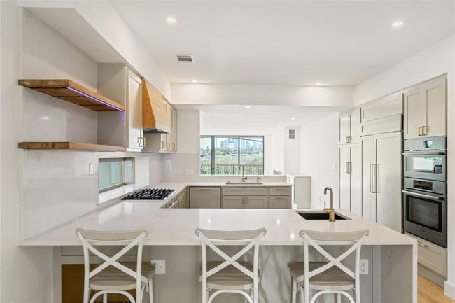Kitchen with barstool seating | Image 25
