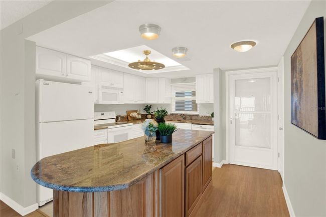 Clean kitchen with island seating | Image 15