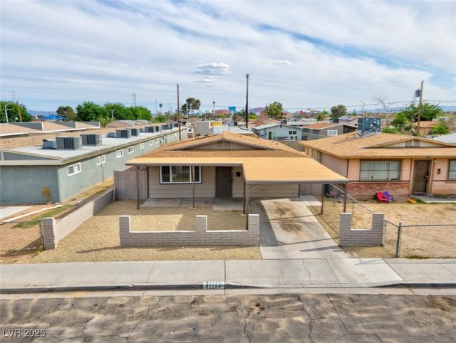 View of front of property with concrete driveway, fence, and a residential view | Image 40