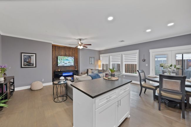 Kitchen with dark countertops, a ceiling fan, baseboards, recessed lighting, and light wood-style flooring | Image 25