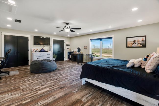 Bedroom featuring a ceiling fan, recessed lighting, visible vents, and wood finished floors | Image 11