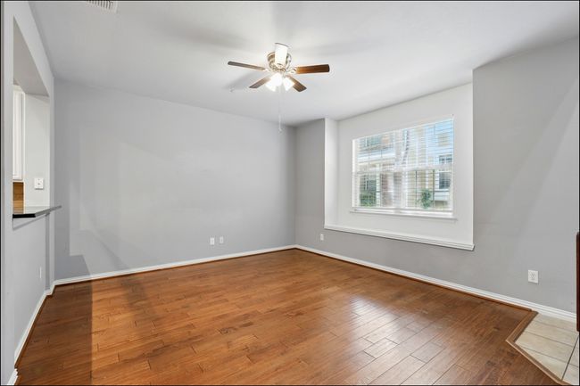 Spare room featuring a ceiling fan, baseboards, and wood finished floors | Image 7