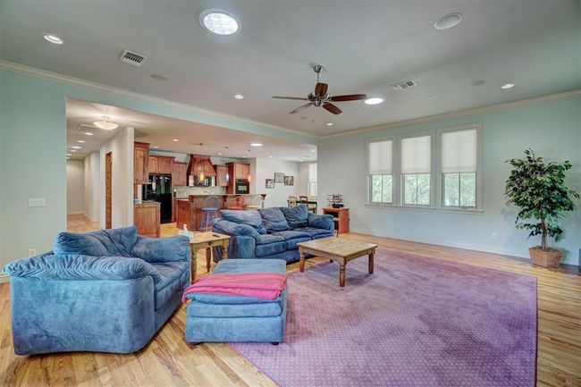 Living area featuring visible vents, ceiling fan, and crown molding | Image 9