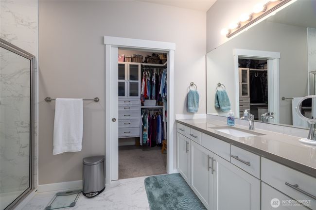 The primary bath has tile floor and a tile shower with lots of counter space! | Image 25