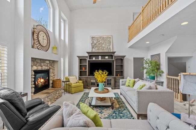 Living area featuring recessed lighting, a towering ceiling, and a fireplace | Image 10