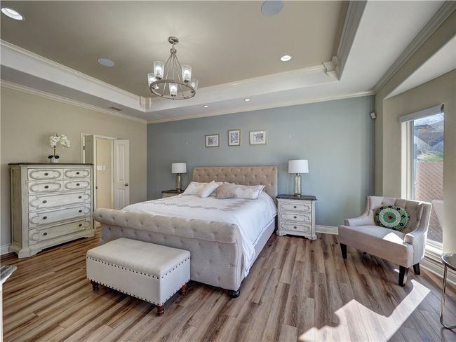 Stunning Master Suite with soft decor colors and motorized blinds. | Image 14