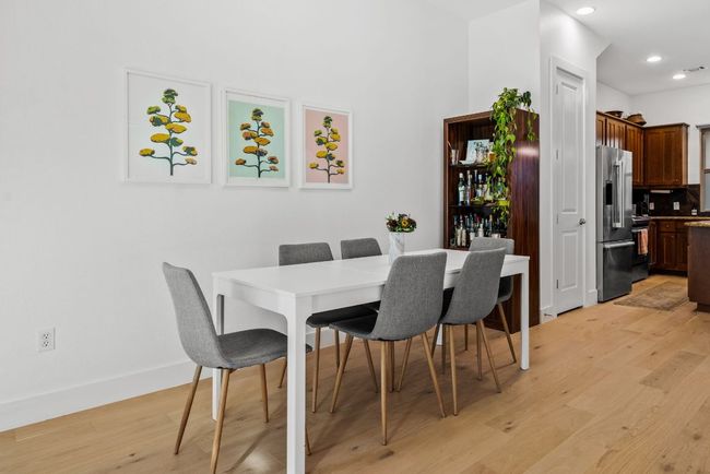 Dining area featuring light wood finished floors and recessed lighting | Image 7