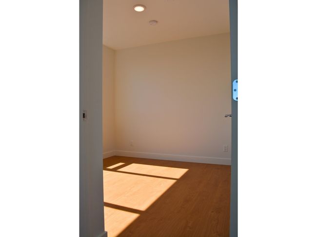 Spare room with baseboards and wood finished floors | Image 11