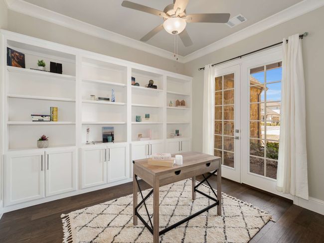 A private study located at the front of the home boasts French doors that open to the front porch and includes a wall of custom built-ins, creating an inspiring workspace. | Image 12