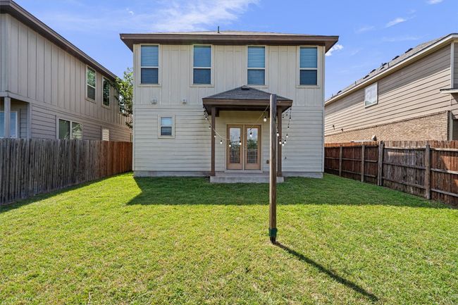 Rear view of property with french doors, a fenced backyard, and board and batten siding | Image 36