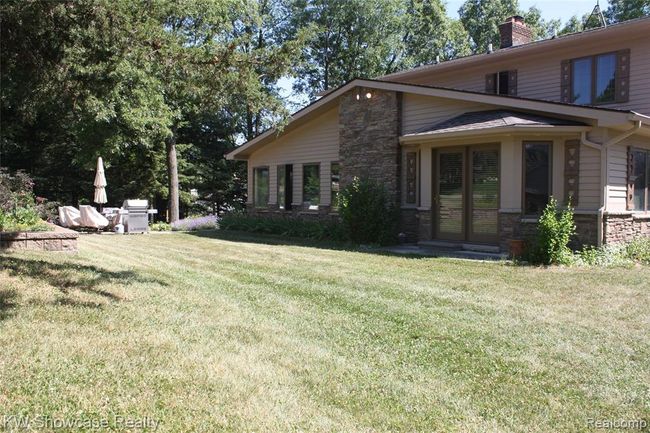 Lower part of yard with back patio. | Image 58