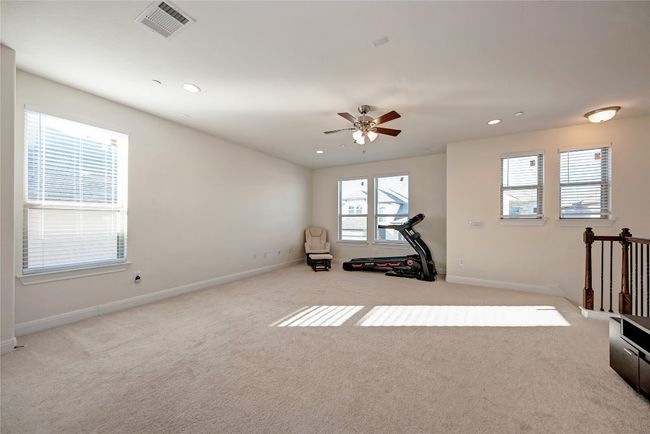 Exercise room featuring baseboards, carpet flooring, recessed lighting, and a ceiling fan | Image 12