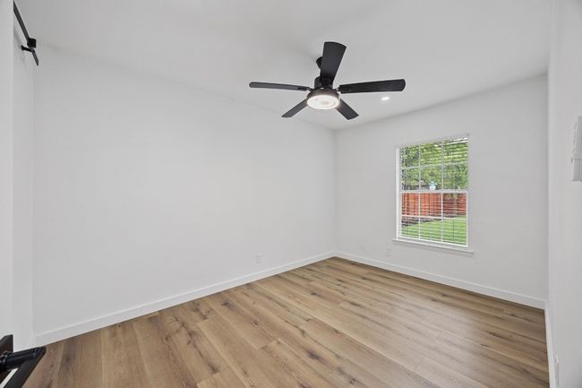 Spare room featuring light wood finished floors, a ceiling fan, and recessed lighting | Image 24