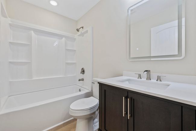 Full bathroom featuring vanity, toilet, tub / shower combination, and wood finished floors | Image 20