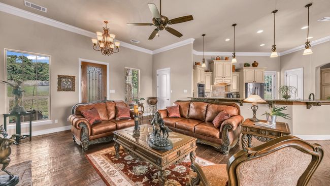 Living area with baseboards, visible vents, and plenty of natural light | Image 7