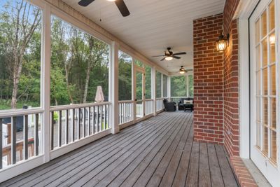 STUNNING screened in back porch with lighting and ceiling fans | Image 2