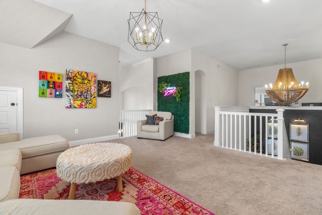 Living room featuring a chandelier, baseboards, carpet, arched walkways, and lofted ceiling | Image 31