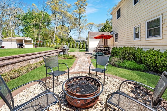 View of patio with an outdoor fire pit | Image 6