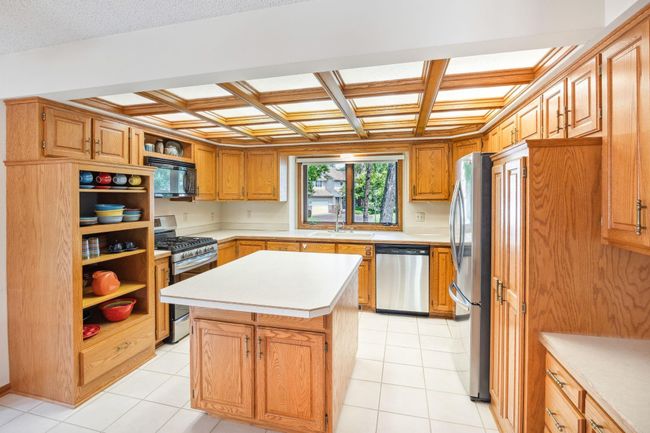 Center island gathering, airy and open with all your wanted/needed cabinets. | Image 6