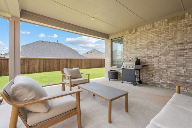 Fenced backyard with a patio and area for grilling | Image 29
