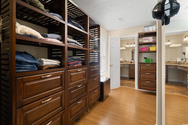 Spacious closet featuring light wood finished floors | Image 12