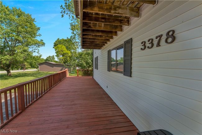 Wooden deck featuring a lawn | Image 4
