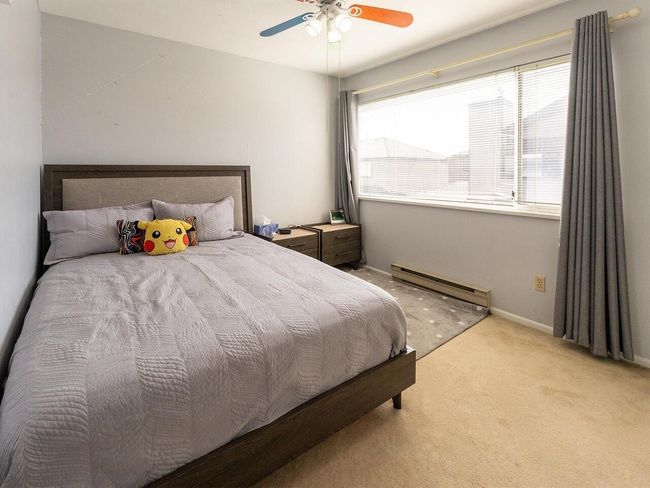 Bedroom with baseboards, light colored carpet, multiple windows, and a baseboard radiator | Image 19