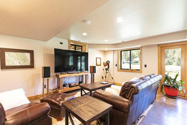 Living area with recessed lighting, baseboards, concrete floors, and a textured ceiling | Image 32