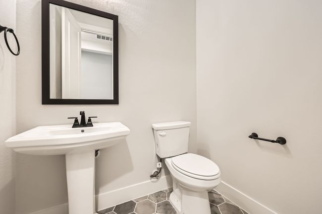 Bathroom with tile patterned floors, toilet, baseboards, and visible vents | Image 12