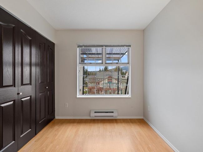 Unfurnished bedroom featuring a closet, baseboards, light wood-style floors, and baseboard heating | Image 16