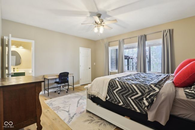bedroom with wood finished floors, ceiling fan, and ensuite bath | Image 45