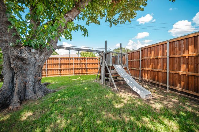 Fenced backyard with a playground | Image 27