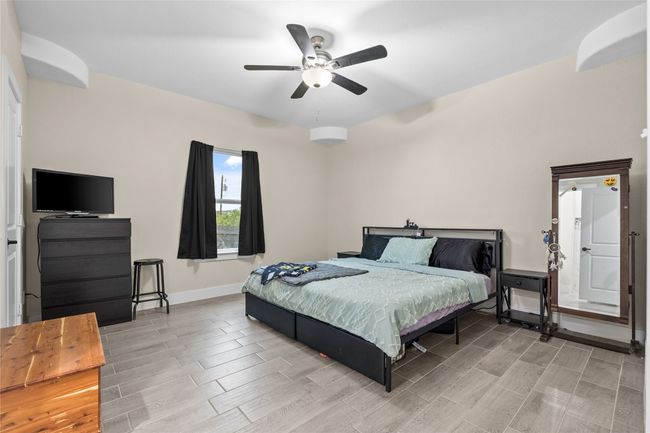 Bedroom with wood tiled floors and ceiling fan | Image 30