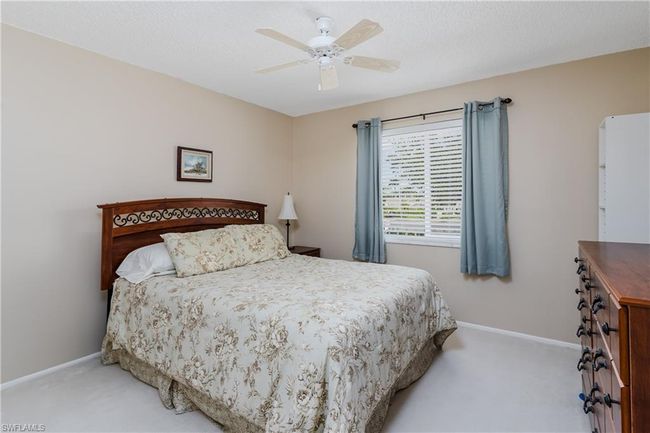 Bedroom with ceiling fan, carpet floors, and baseboards | Image 19