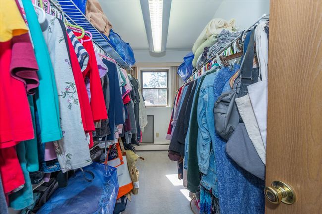 Walk in closet with beamed ceiling and carpet | Image 30