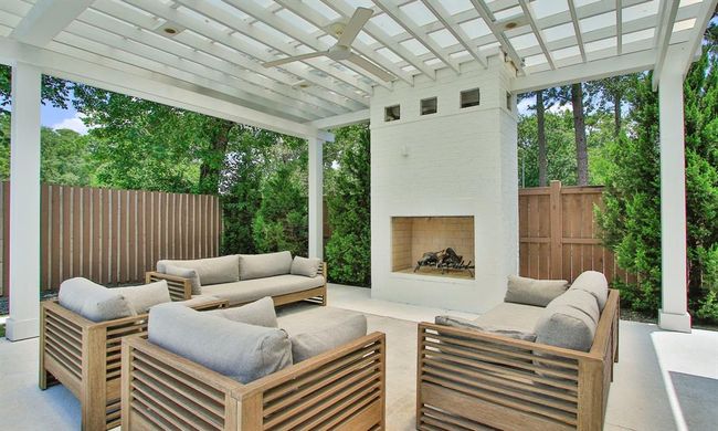 A custom fireplace with a pergola creates a fantastic outdoor haven for relaxing and entertaining. | Image 36