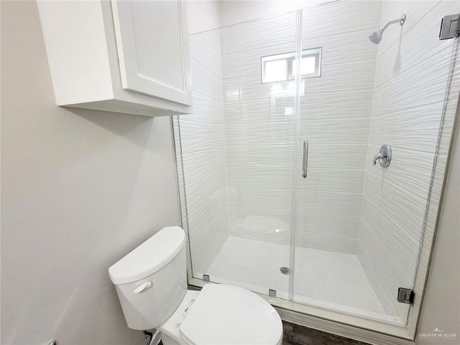 Full bathroom with a shower stall and toilet | Image 10