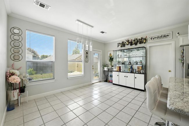 Dining space featuring crown molding and light tile patterned flooring | Image 16