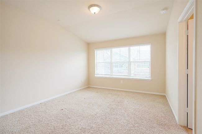 Empty room featuring light colored carpet and vaulted ceiling | Image 12