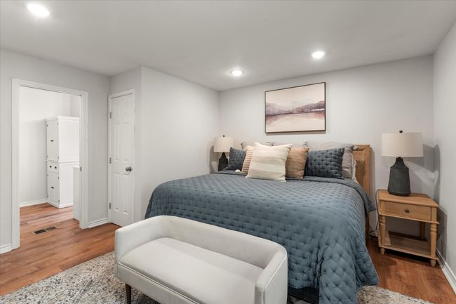 Bedroom featuring recessed lighting, wood finished floors, visible vents, and baseboards | Image 28