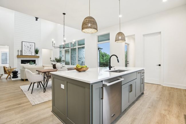 A chef’s dream kitchen, equipped with a massive island, double ovens, and custom cabinetry. | Image 18