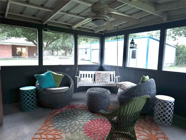 Sunroom / solarium with a ceiling fan, plenty of natural light, and an outdoor hangout area | Image 20