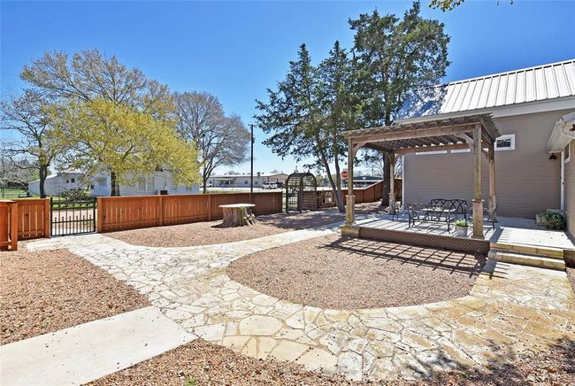 Another view of the Guest house. Notice the gates from the garage and one for guests. Don't you just love the flatwork at this property. | Image 32